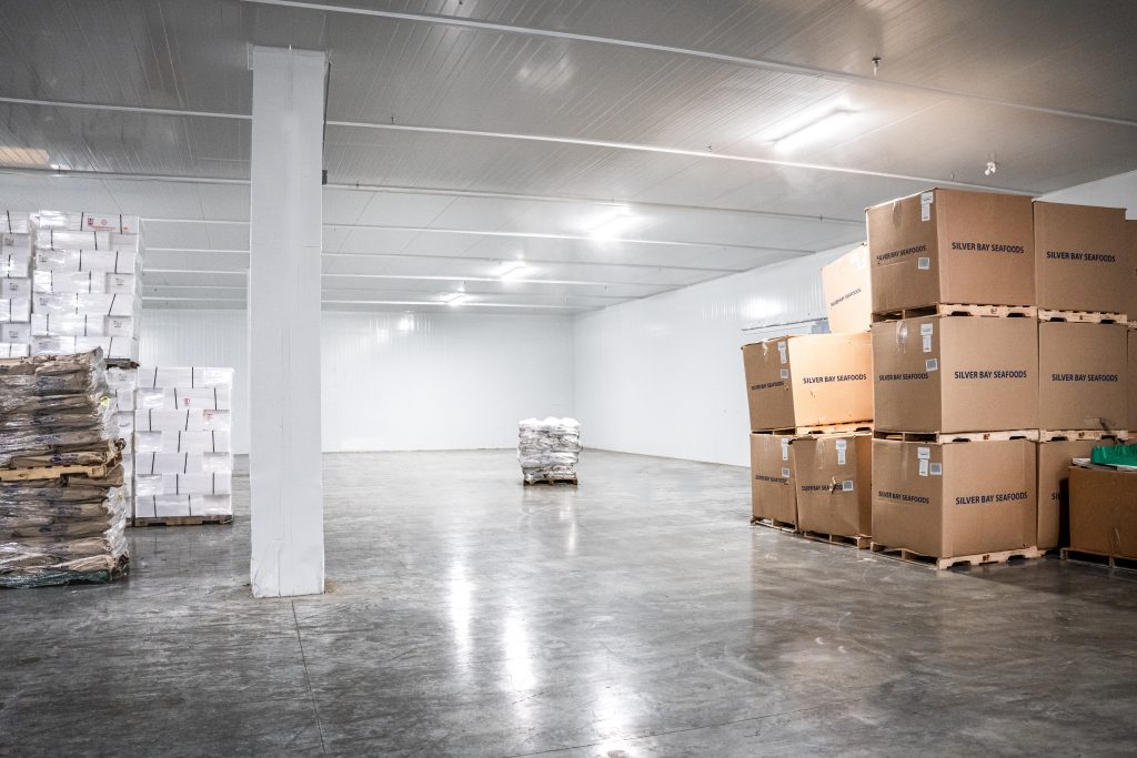 Cold storage freezer with boxes of product inside.